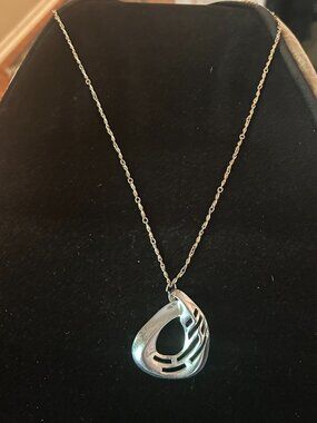Silver tone abstract pendant with chain